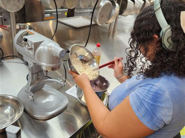 Student using stand mixer